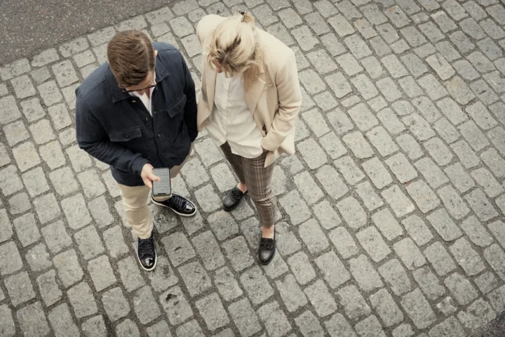 Two people looking at a phone